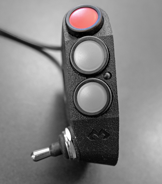 Shows DMD Remote 3 rally edition with its 3 buttons and lower switch in detail