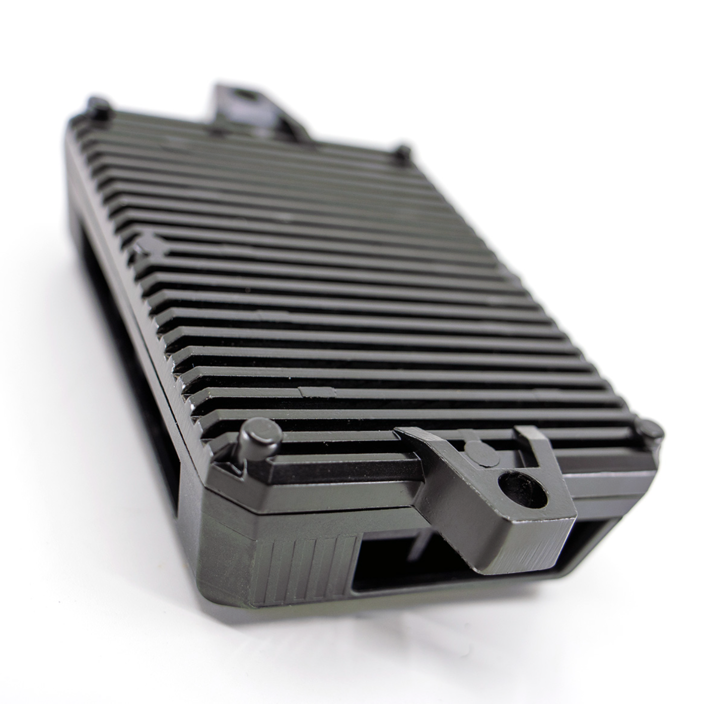 **Shows the back of the DMD Power Box with cooling fins and a mounting point.**