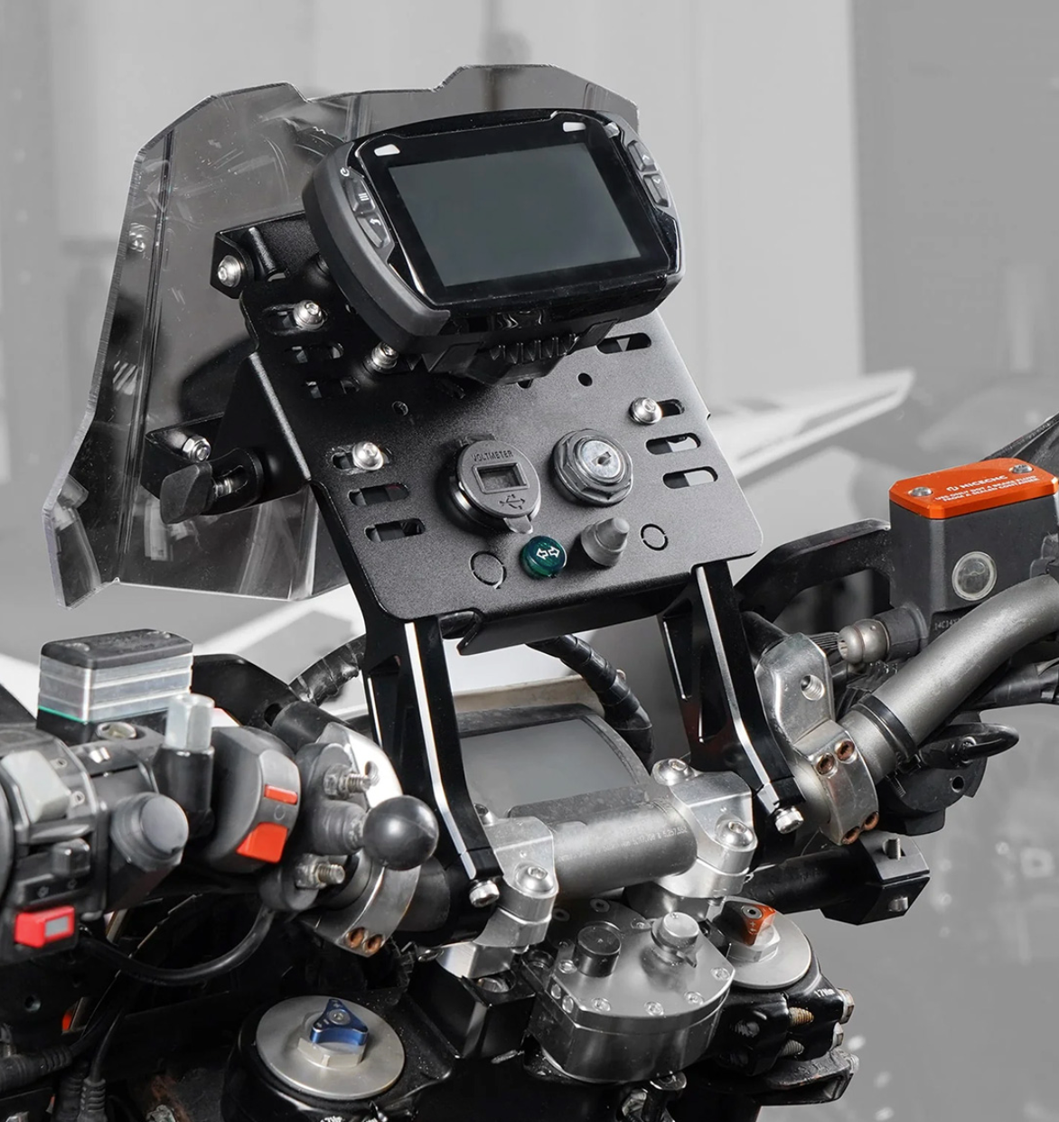 The image shows the DMD Handlebar Mount Tower, a mini fairing designed for low windshield adventure motorcycles. It mounts directly to handlebars and is compatible with bikes using either 22mm or 28mm bars. View on mounting plate.